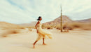 Woman Running in a Desert Landscape with Cacti