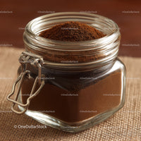 Glass Jar Filled with Fine Ground Coffee and Coffee Beans