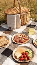 Sunny picnic setup with charcuterie and fresh fruits