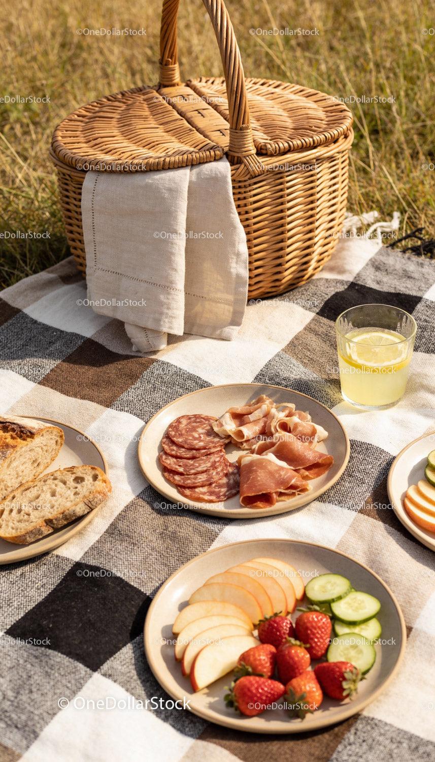 Sunny picnic setup with charcuterie and fresh fruits
