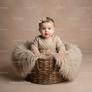Adorable Baby Sitting in Cozy Basket with Fur Blanket