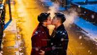Couple Sharing a Tender Kiss on Snowy Winter Evening