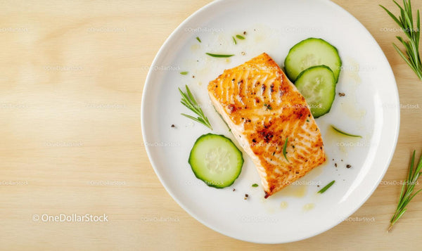 Healthy Grilled Salmon with Cucumber Slices on White Plate