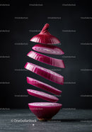 Floating slices of red onion against dark background