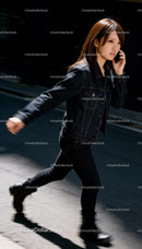 Young woman walking outside while talking on phone