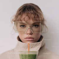 Young Woman in Safety Glasses Drinking Green Smoothie in Modern Style