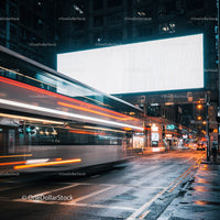 City street with light trails from passing double-decker bus