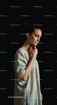 Thoughtful young woman standing in soft light