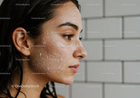 Side portrait of young woman with facial exfoliating scrub