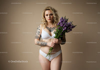 Attractive Woman in White Lingerie Holding Lavender Bouquet Studio Portrait