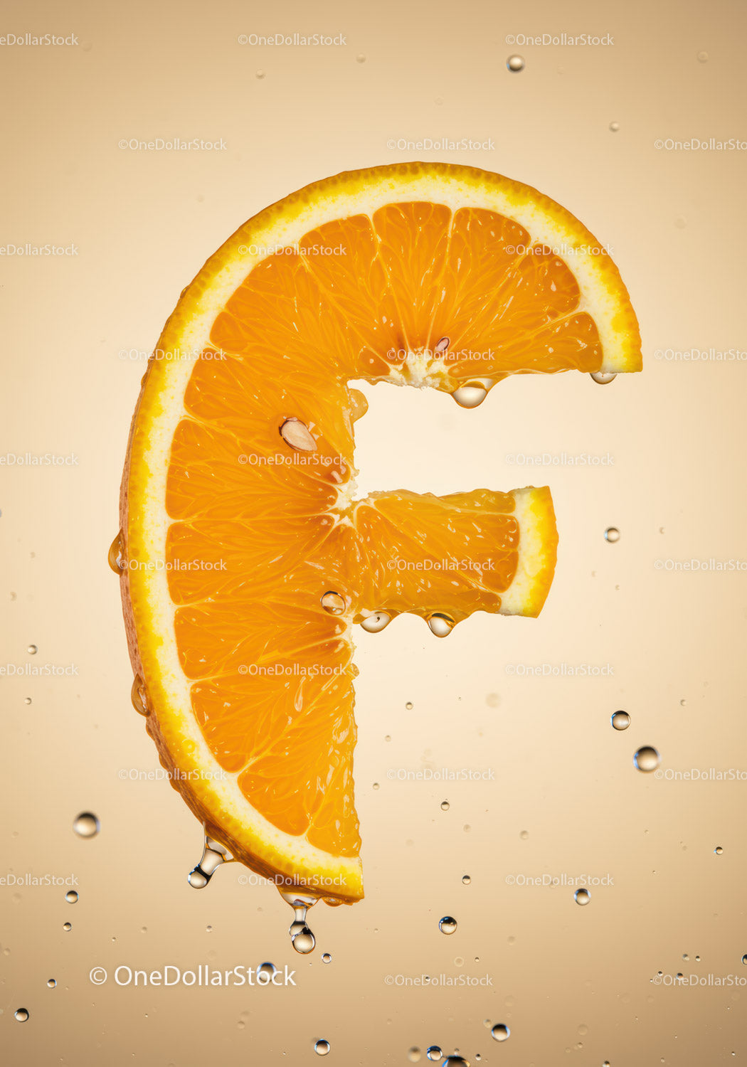 Fresh orange slice shaped like letter F with water drops