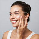 Young Woman Applying Moisturizer for Healthy Glowing Skin