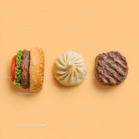 Gourmet Burger with Lettuce and Tomato Next to Grilled Steak and Dumpling