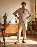 Casual young man standing in sunlit cozy interior