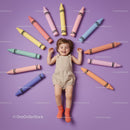 Happy toddler lying surrounded by colorful giant crayons