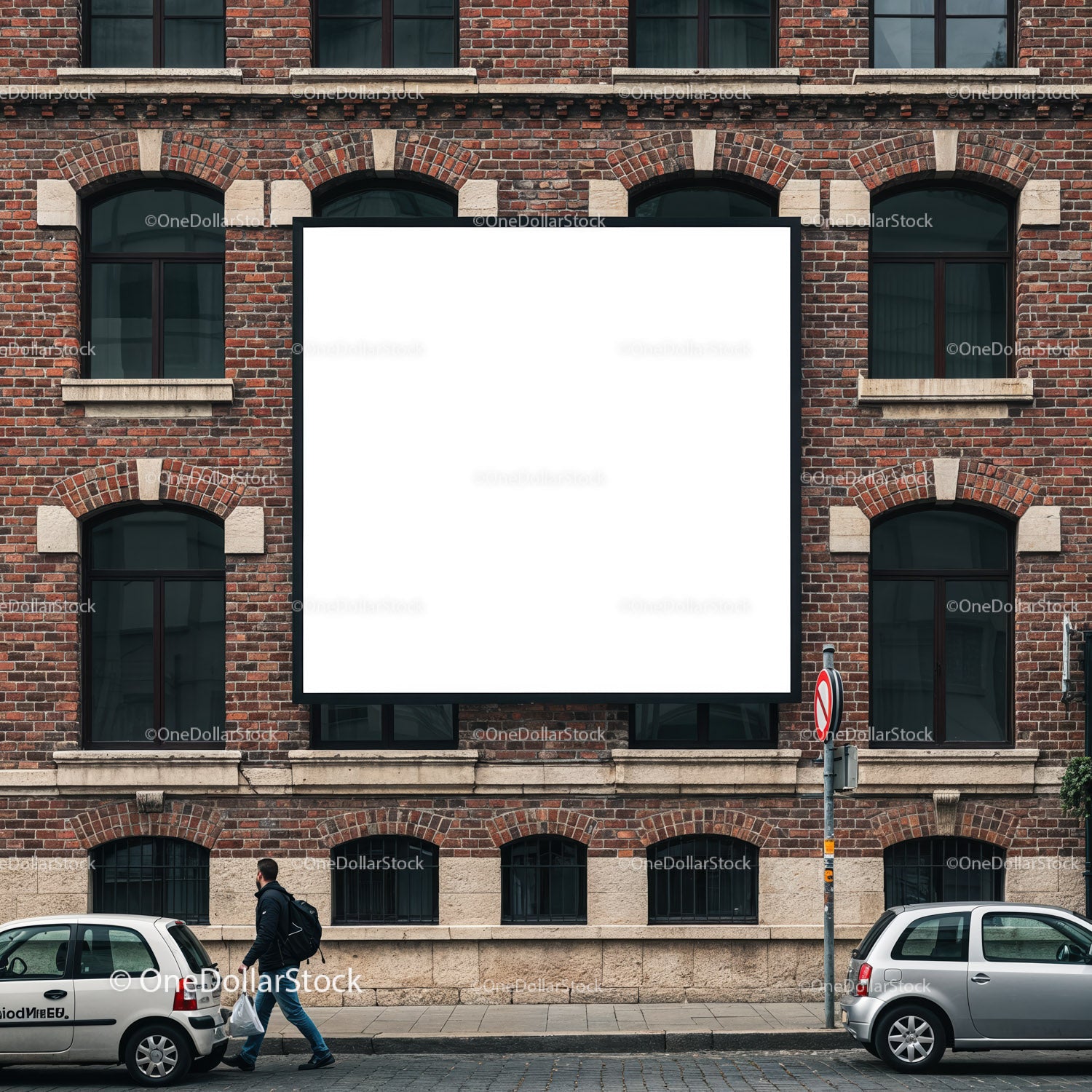 Mężczyzna w mieście przechodzący obok pustego billboardu na ceglanej ścianie
