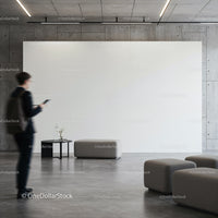 Modern minimalist lobby with seating and blank wall