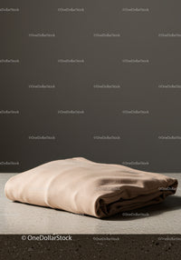 Elegant Beige Fabric Folded on Surface for Home Decor and Fashion