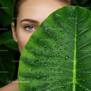 Close-up of a Woman with a Green Leaf in a Tropical Jungle Scene