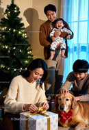 Family enjoying Christmas with dog and gifts at home
