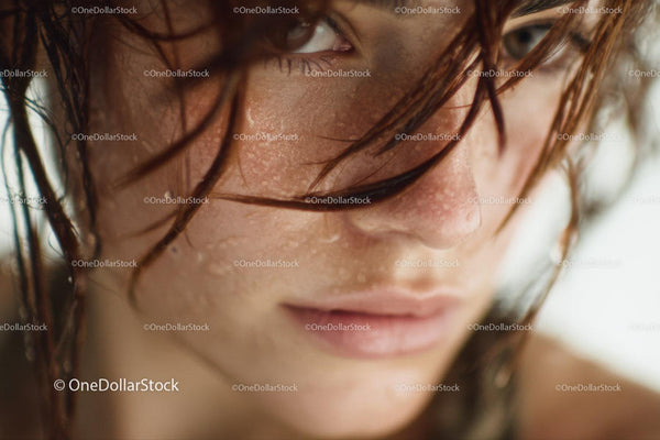 Close-Up of a Woman with Wet Hair and Water Droplets