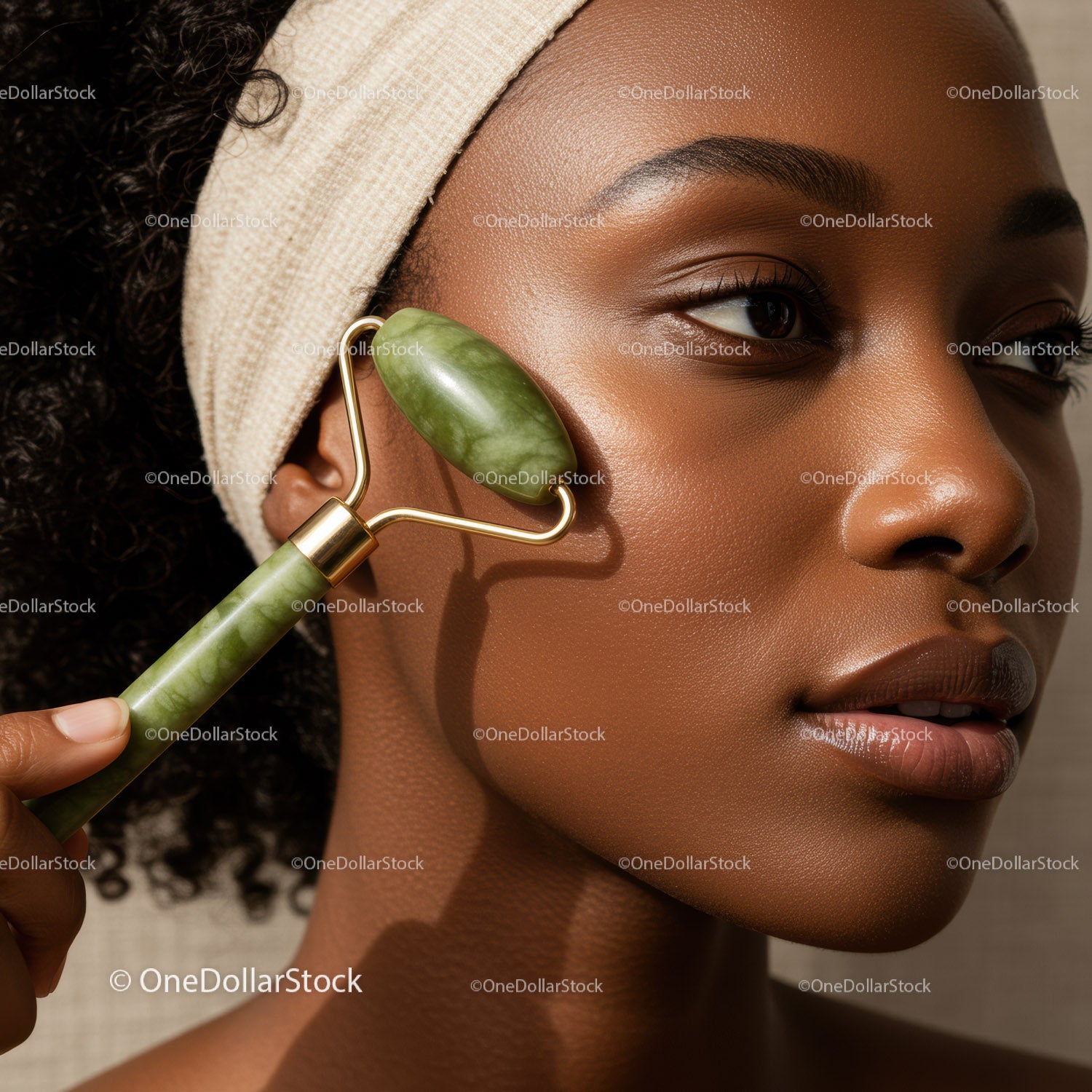 Young African Woman Using Jade Facial Roller for Skin Rejuvenation