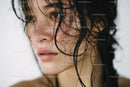 Close-up of a Wet-Haired Woman with Brown Eyes and Freckles