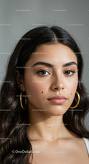 Elegant Portrait of a Young Woman with Brown Eyes and Gold Earrings