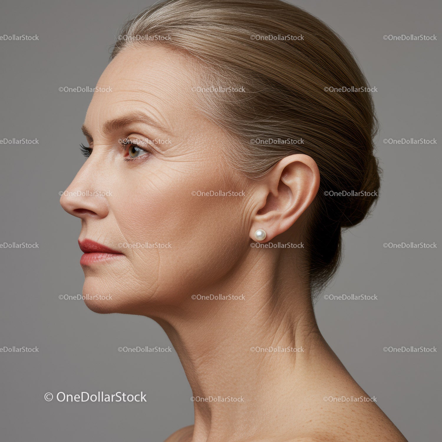 Elegant Mature Woman Profile Portrait with Pearl Earring in Studio