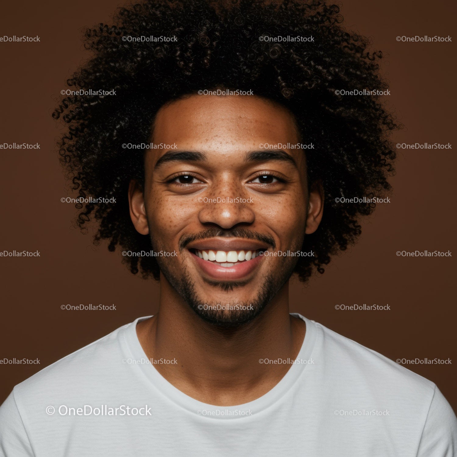 Bright Smiling Man with Curly Hair in Casual White T-Shirt