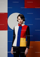 Woman in Color Block Jacket Against Geometric Background