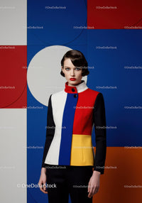 Woman in Color Block Jacket Against Geometric Background