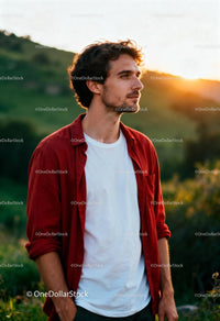 Young man enjoying peaceful sunset in nature