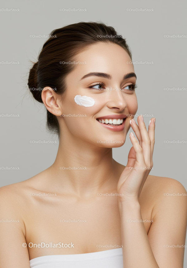 Fresh Smiling Woman Applying Cream on Cheek for Glowing Skin