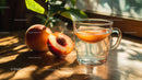 Peach Fruit and Fresh Herbal Tea in Sunlit Setting