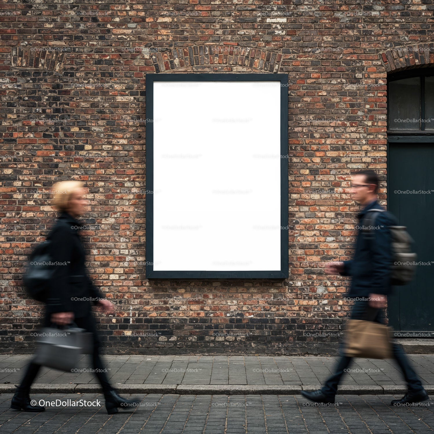 Two blurred pedestrians passing blank urban billboard
