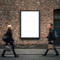 Two blurred pedestrians passing blank urban billboard