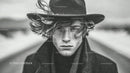 Monochrome Portrait of Young Man with Wide-Brimmed Hat and Intense Gaze