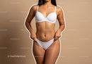 Elegant Toned Woman in White Lingerie Against Beige Background