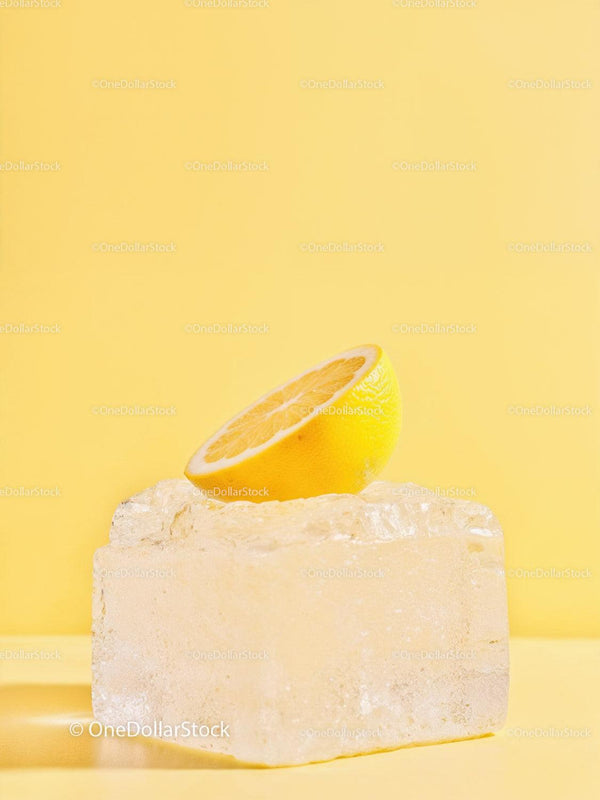 Fresh Lemon Half Balanced on Large Ice Cube