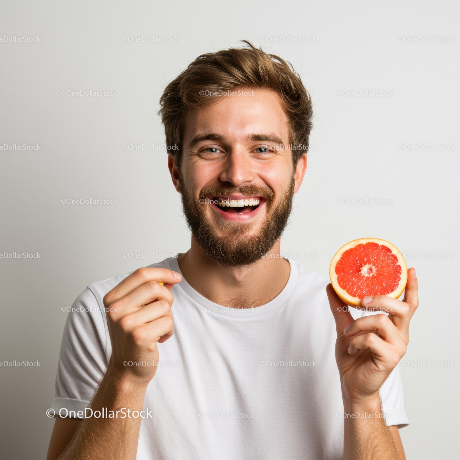 Young Man Smiling While Holding Juicy Grapefruit for Refreshing Lifestyle