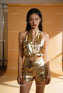 Young woman in stylish metallic gold outfit posing