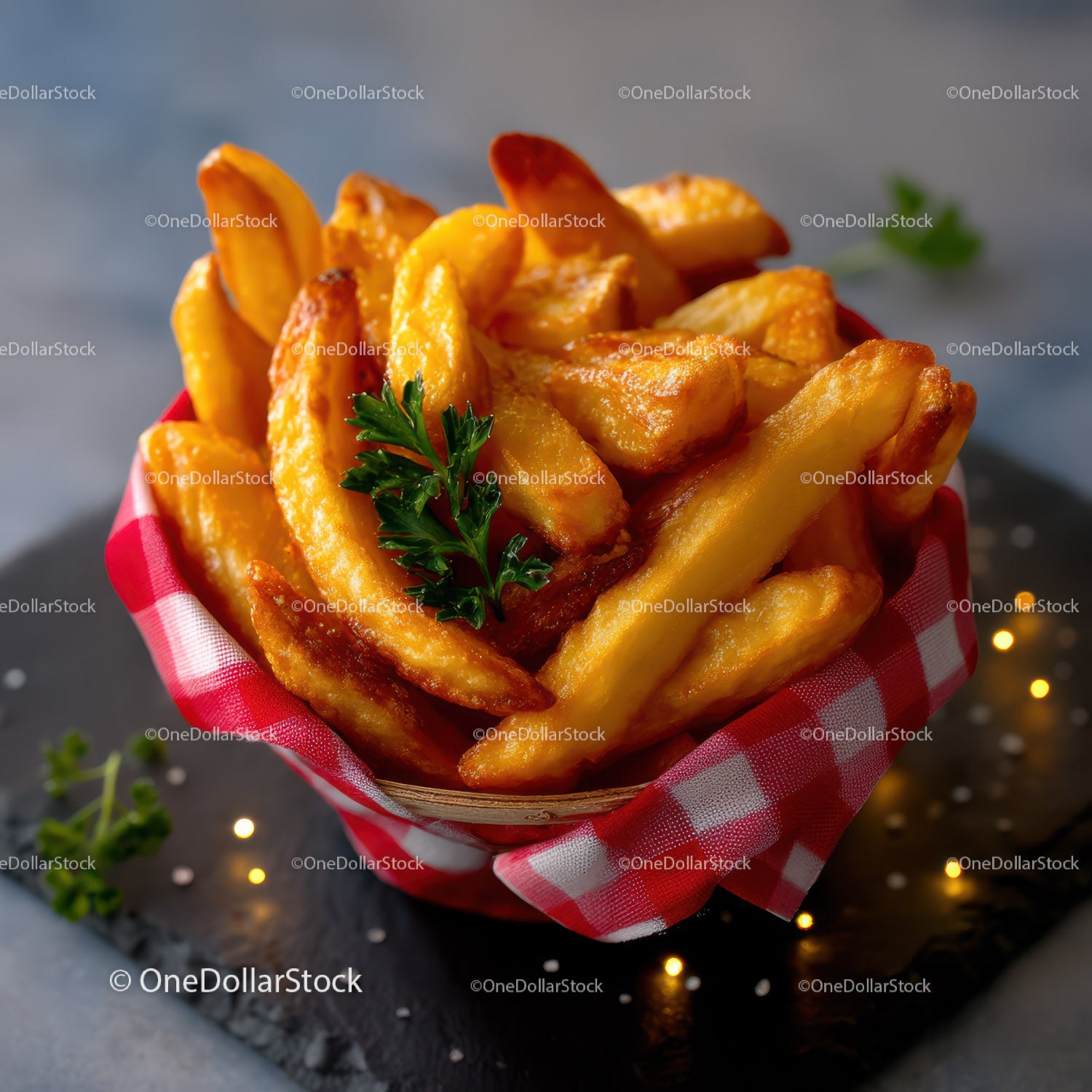 Golden French Fries in Bowl with Green Garnish on Black Surface