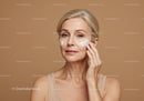 Elderly Woman Applying Moisturizer for Skincare Routine