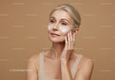 Elegant Mature Woman Applying Face Cream for Skincare Routine