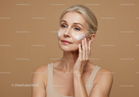 Elegant Mature Woman Applying Face Cream for Skincare Routine