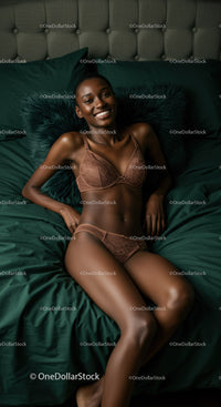 Smiling woman relaxing on dark green bed in lingerie