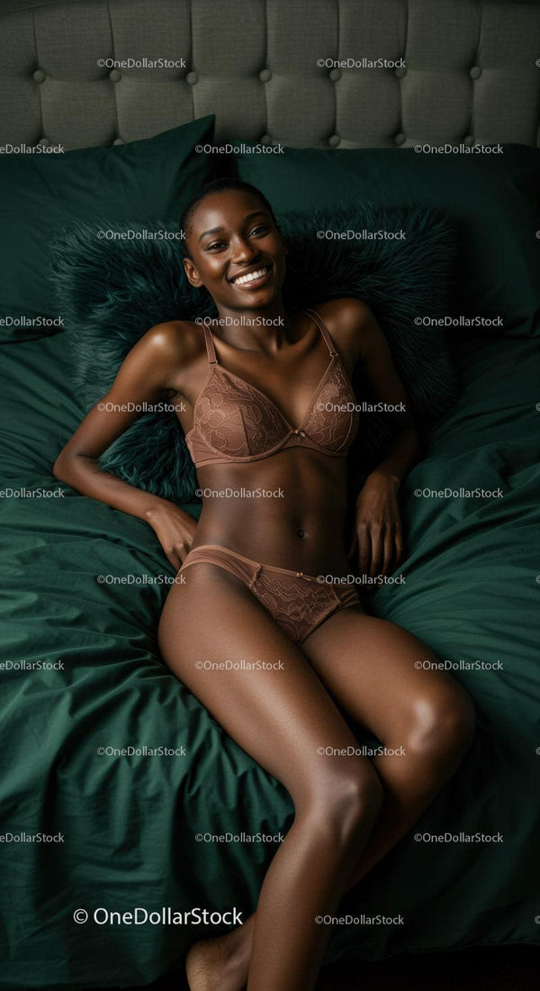 Smiling woman relaxing on dark green bed in lingerie