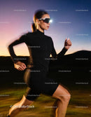 Female runner jogging outdoors at dusk in sportwear