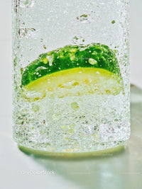 Fresh cucumber slice frozen inside clear ice cube